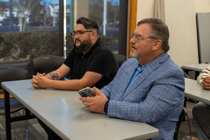 Two educators at a table in a workshop setting